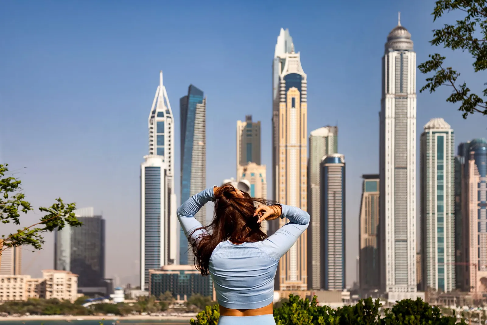 Tourist looking at the Dubai skyscraper skyline, representing resort and lifestyle hotel options in Dubai.